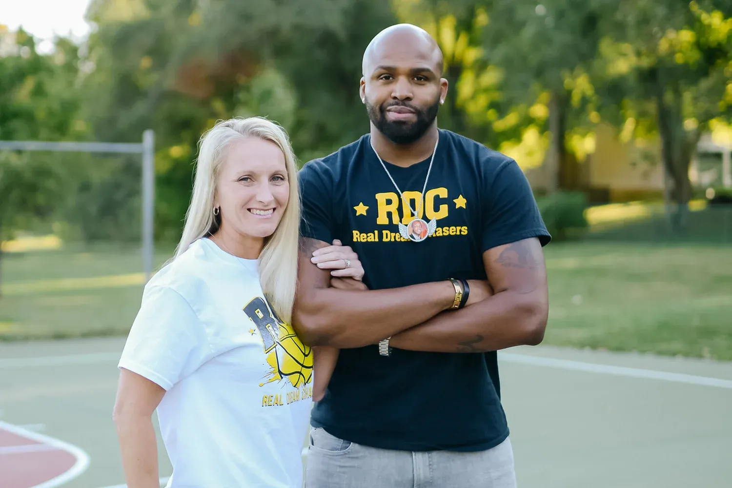 RDC founders Alissa and Ronnie Powell standing on a basketball court